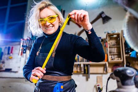 Busy wood designer in a small carpentry workshopの写真素材