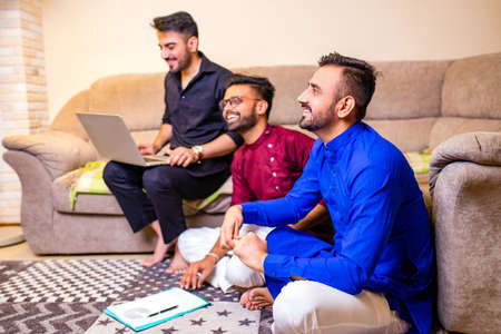 friends from india talking in living room and have funの写真素材