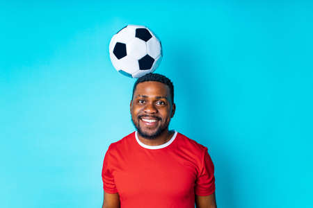 happiness brazilian player man over isolated blue backgroundの写真素材