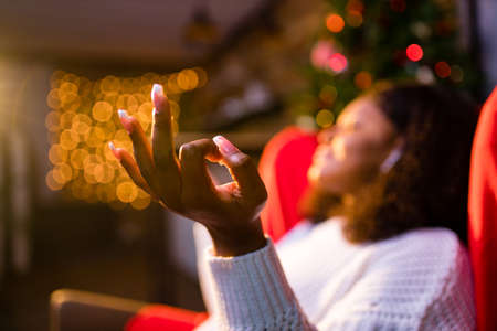 Serene young woman closed eyes relaxing leaned on couch modern wireless headphones in an ear podsの写真素材