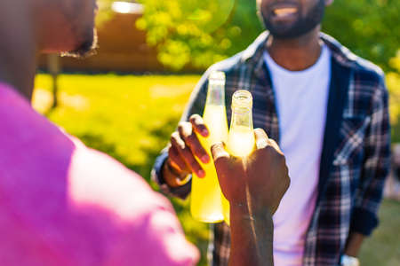 latin american people spending evening sunset together in summer parkの写真素材
