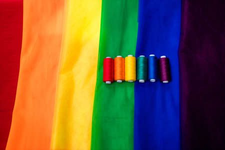 multi-colored pieces of fabric and a threads on the table preparation for the ride parade lgbtの写真素材