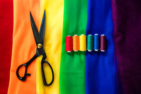 multi-colored pieces of fabric and a threads on the table preparation for the ride parade lgbtの写真素材