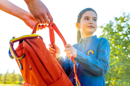 preteen latin kid schoolgirl student wears uniform and backpack outdoorsの写真素材
