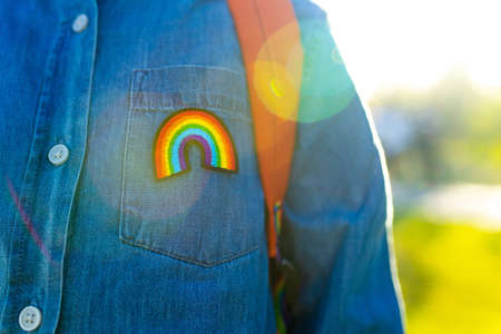 girl in denim t-shirt with rainbow symbol wear backpack in summer park outdoorの写真素材