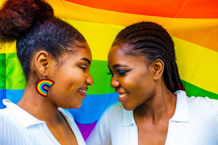 african american couple of two young beautyful women in summer parkの写真素材