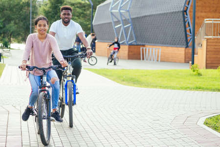 mixed race couple taking a cycle on rent phone appの写真素材