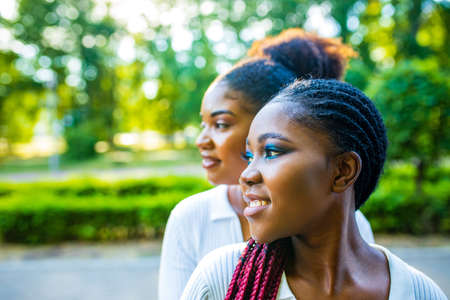 brazilian lesbian couple in white dress spending time together celebrating engagement in summer park outdoorの写真素材