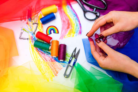 multi-colored pieces of fabric and a threads on the table preparation for the ride parade lgbt