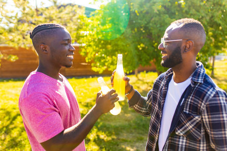 african american brothers spending summer holiday in sunny parkの写真素材