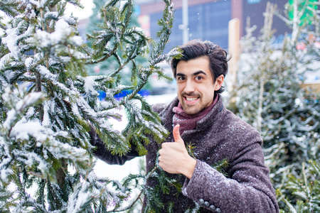 italian man buying Christmas tree at X-mas new year in open air shopの写真素材