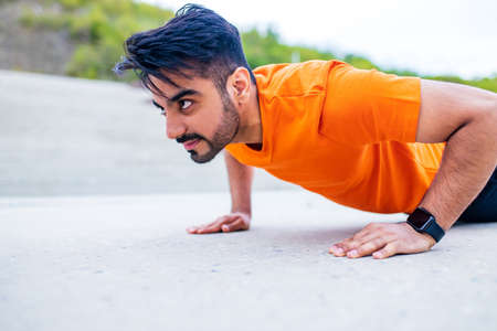 eastern ethnic people exercising together outdoor on sun lightの写真素材