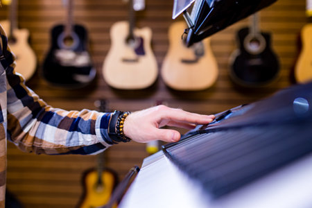 redhair ginger beard man is playing on piano in music storeの写真素材
