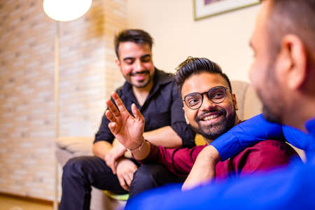 indian people talking in living room in evening meeting