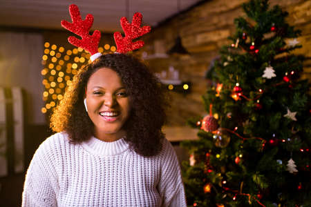 happy woman against the background of a garland of lamps Christmas and New Years conceptの写真素材