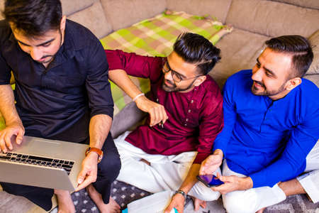 friends from india talking in living room and have fun