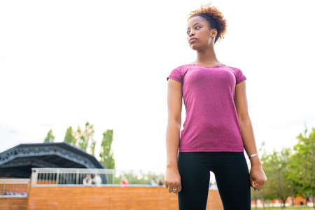 strong brazilian woman posing outdoor sity background