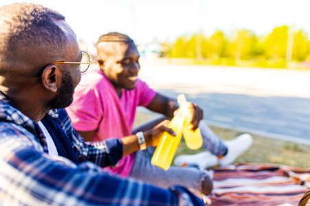 latin american people spending evening sunset together in summer park