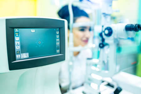 arabian patient checking eyesight and vision correction in optometrist lab