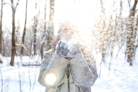 woman walking in snow park Christmas holidays outdoorの写真素材