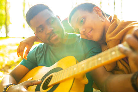 two happy african american people in love spending time outdoors in campの写真素材