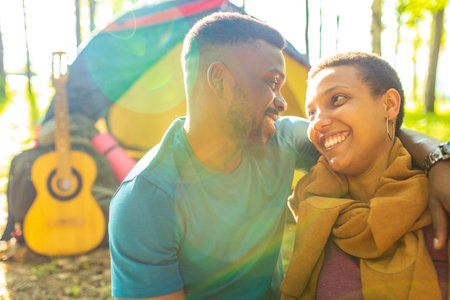 african people on camping trip welcoming a new day in summer parkの写真素材