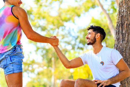 young same sex couple in love outdoors together showing all of feelsの写真素材