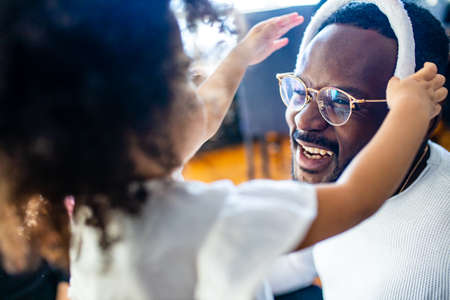 authentic ethnic multicultural people wearing bunny ears in living room day sunlightの写真素材