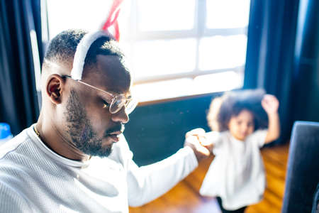 tired dresses on a bunny ears father sleep while playing with her cute daughter on easterの写真素材