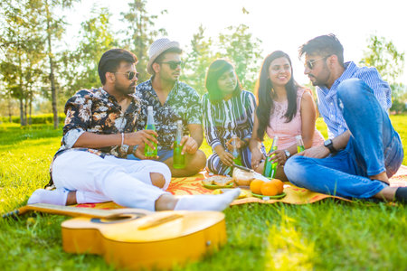 multiethnic people spending time together playing guitarの写真素材