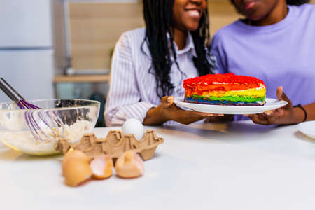 Happy loving same sex couple is preparing the pastry in the kitchenの写真素材