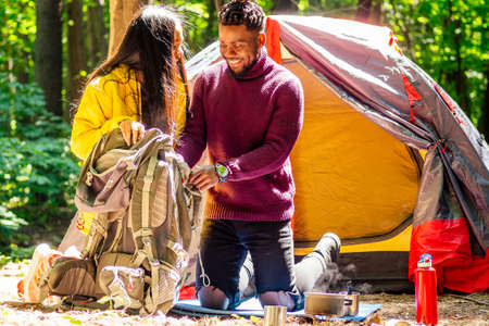 latin american man and hispanic woman in a forest having a restの写真素材