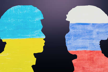 military silhouettes and flags of Russia and Ukraine painted on paper. Russian versus Ukraine trade third world war disputes and anctions policy conceptの写真素材