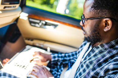 Handsome bearded man sitting relaxed in his newly bought car outdoors