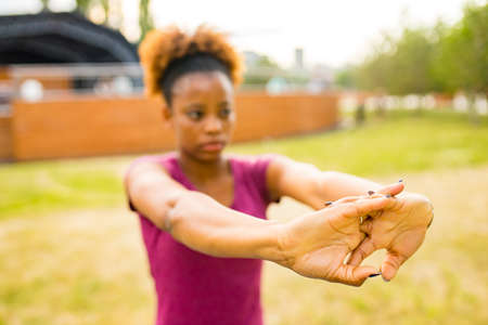 Fit young african american woman in sport activity outdoors ready for run in morningの写真素材
