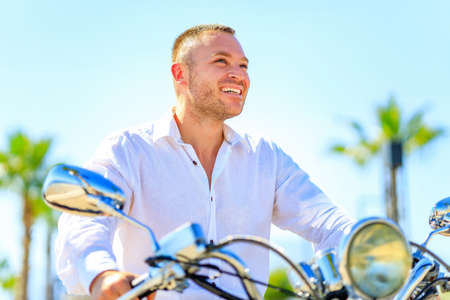 Fashion man with scooter in helmet in paradise tropics