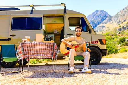 young indian man vacation travel RV, holiday trip in motorhome in mountainの写真素材