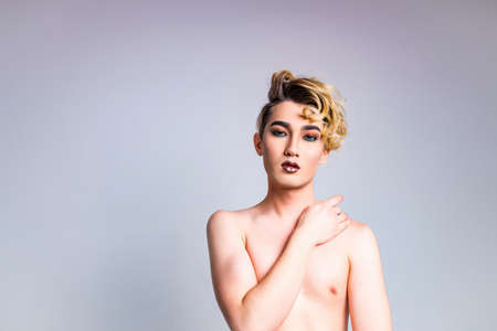 body positive i love myself man with gorgeous make up and hairstyle in studio white backgroundの写真素材