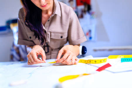 seamstress working at her working table at home studio