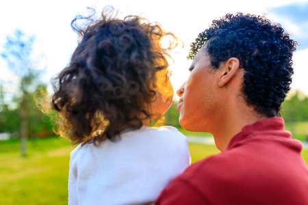 multicultural race enjoy father carrying little african girl child smiling in summer park
