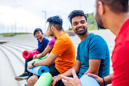 four indian people warming up outdoors in sport wear morning time urban