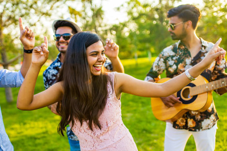 multiethnic people spending time together playing guitarの写真素材