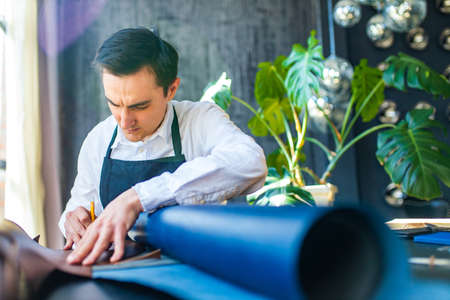 skilled shoemaker make a leather shoes in workshopの写真素材