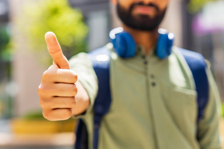 student looking happy and showing friendly gesture outdoors
