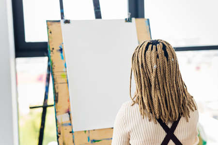 brazilian woman with dreadlocks in white blouse in art studioの写真素材