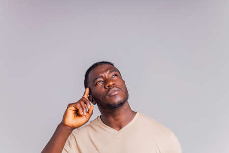 latin brazilian man holding a lightbulb in hands concept of idea and creativityの写真素材