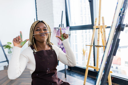 Young african student with septum nose piercing at the art studioの写真素材