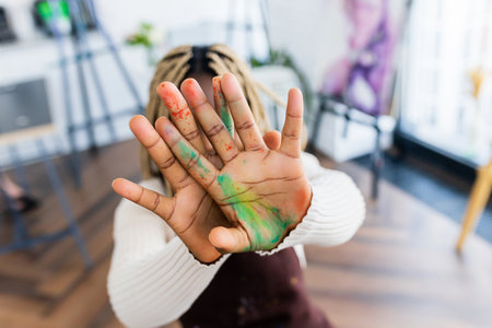 brazilian woman with dreadlocks in white blouse in art studioの写真素材