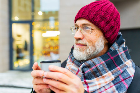 happy mature man in winter christmas market outdoors with cityscape in the background