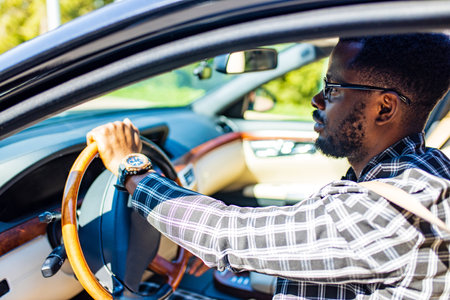 latin hispanic man in a stylish plaid suit wear glasses in luxury sports carの写真素材